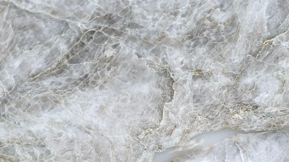 Taj Mahal quartz countertop slab with creamy white base and subtle gold and gray veining for luxury kitchens  
