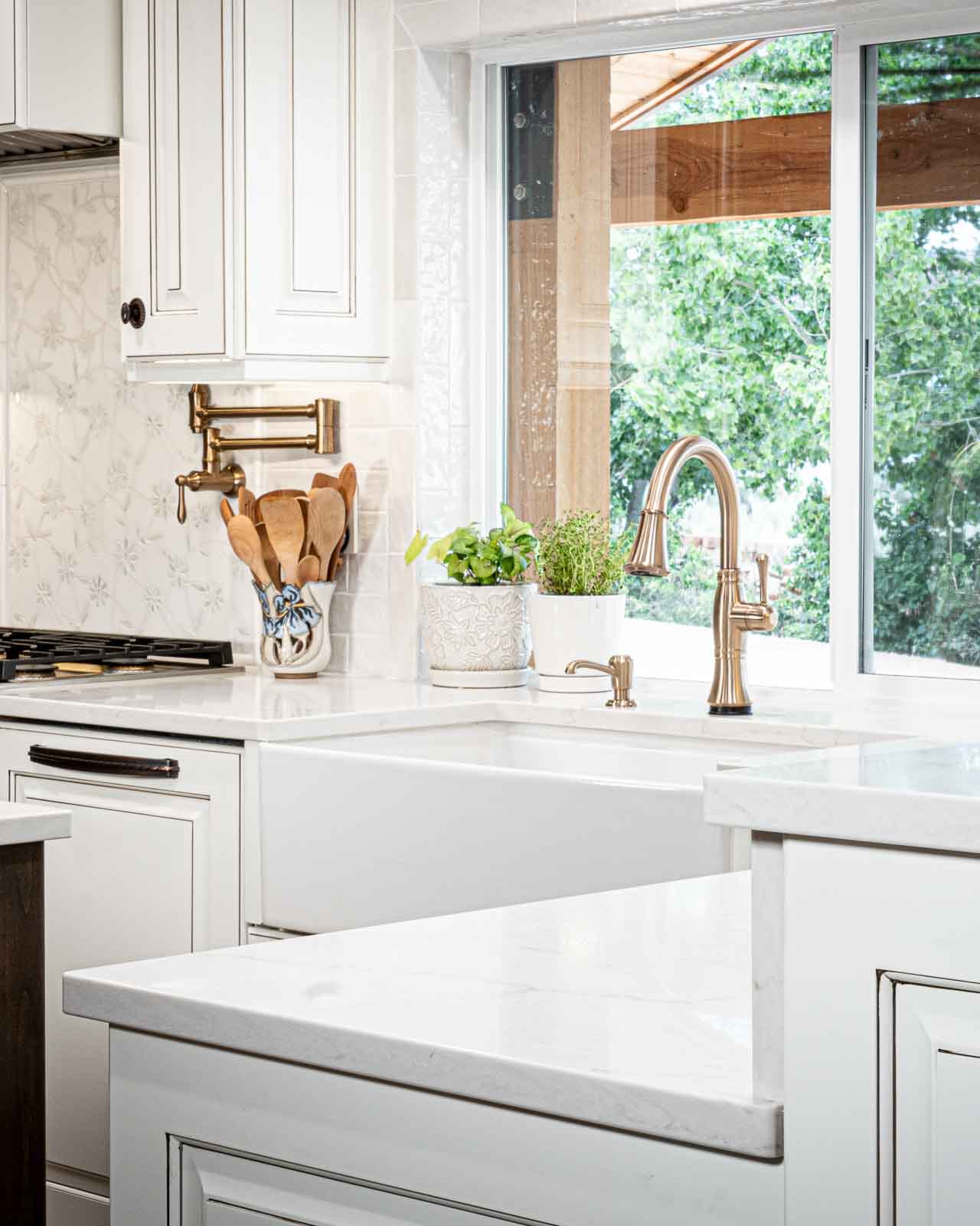 Kitchen countertop with white surface, waterfall edge, and modern cabinetry in Southern Utah