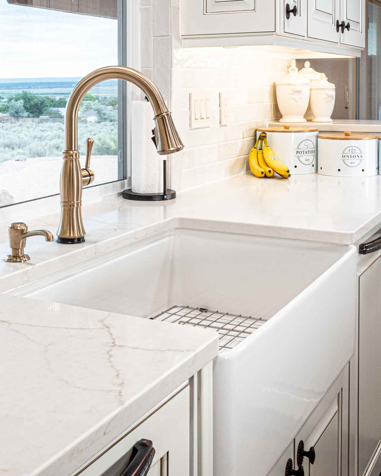 Bathroom countertop installation with white surface and brass fixtures in Southern Utah