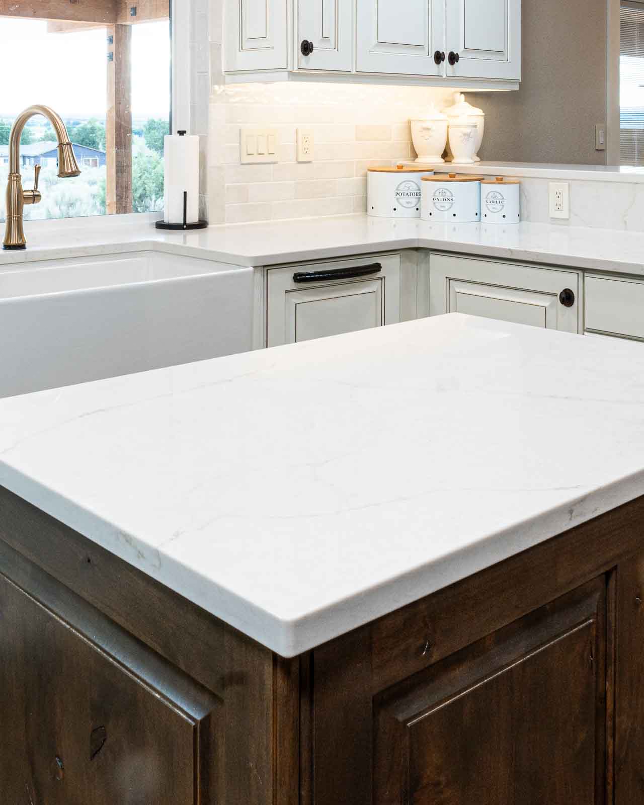 White kitchen countertop with waterfall edge and farmhouse sink in Kanab Utah home